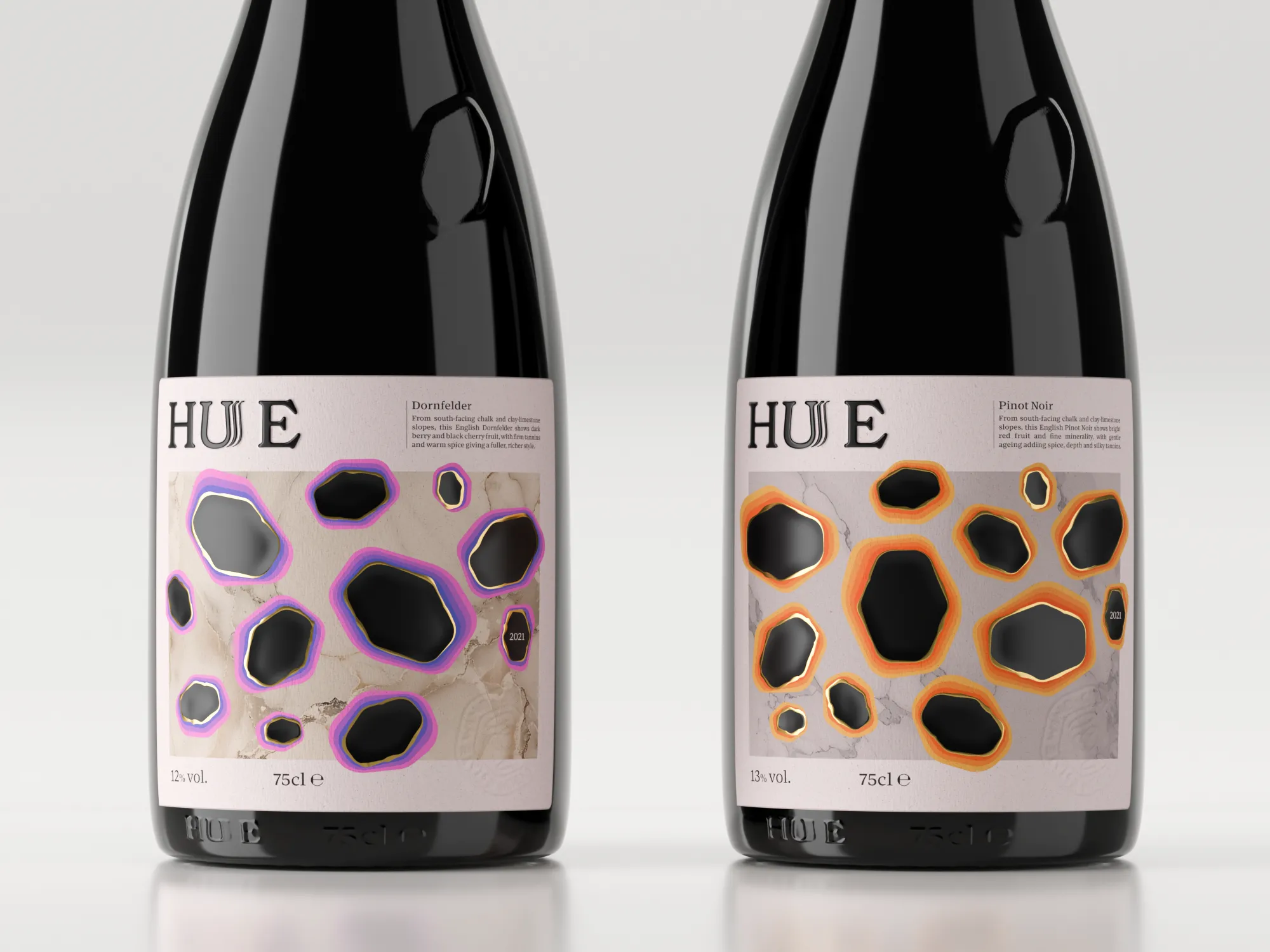 Two HUE English wine bottles displayed on a textured stone plinth